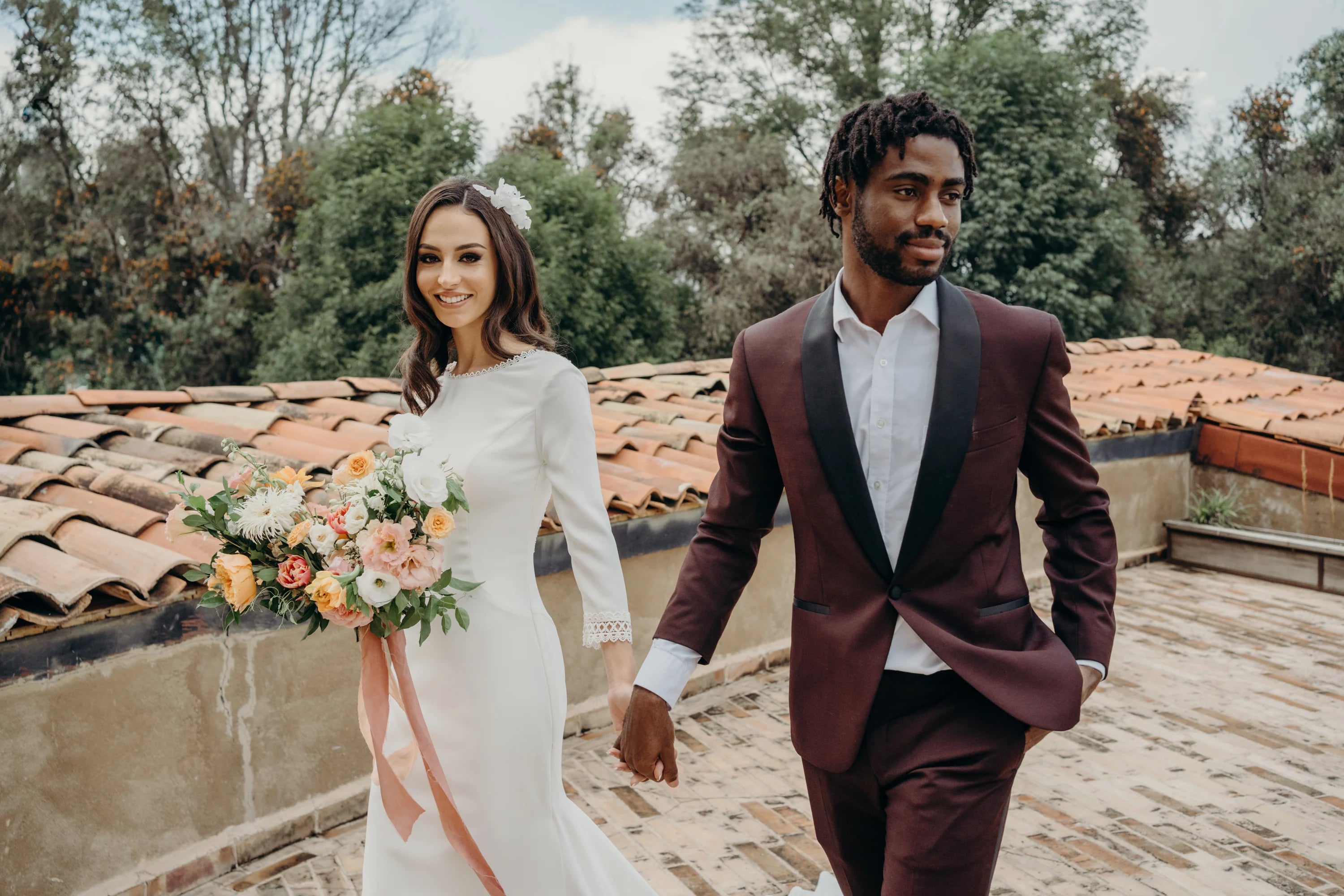 wedding, a couple holding hands with a flowerbouqet